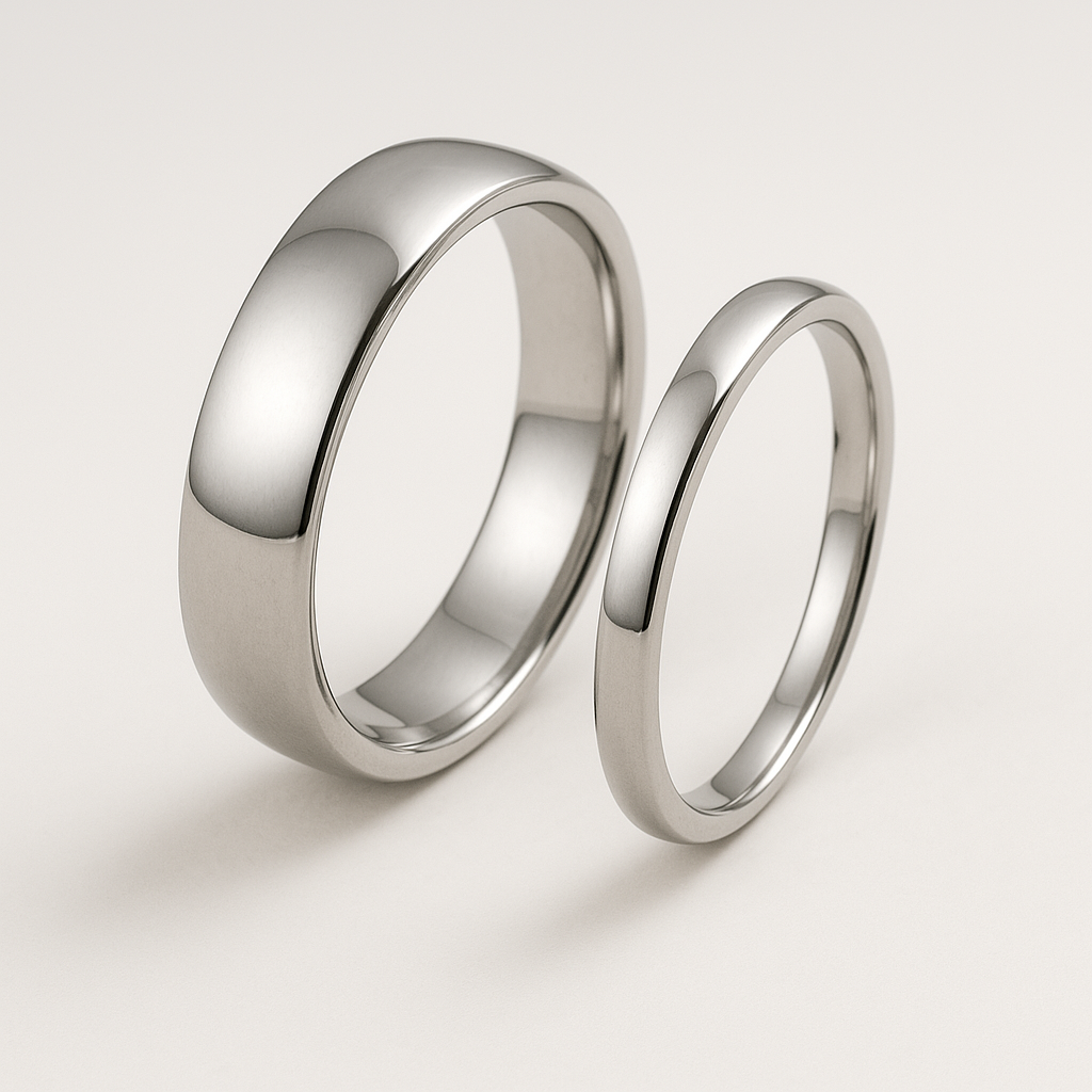 Pair of Platinum Wedding Rings One Wide the other narrow both with a polished finish